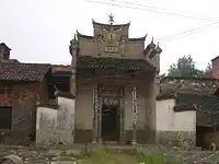 This shrine to a Master Yong in a Yangxin County village, Hubei features a tablet, high in the facade, saying "The Three Stars are Present". The symbol at the top of the facade is a stylised derivation of the character shou , "longevity"