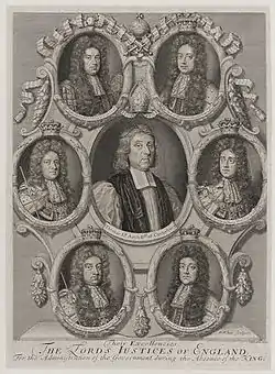  Black-and-white depiction of six small portraits arrayed in a circle around a larger portrait