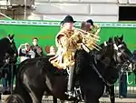 Bandsmen of the Household Cavalry mounted band in state dress, wearing the traditional style of velvet jockey's cap.