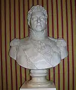 Bust of a curly-haired man wearing a high collared military uniform with epaulettes.