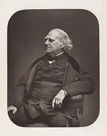 Formal photographic portrait of Blanquart-Evrard seated in a chair