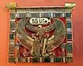 hieroglyphs: uraeus, mut, Djed pillar, shen ring, naos (shrine)cartouche: adze, was scepter, sun disk, Maat hieroglyph, N-water ripple (n hieroglyph)