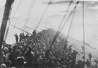 The crew of the sinking Zuikaku salute as the flag is lowered on 25 October 1944.