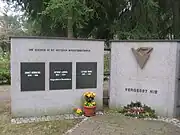 On a memorial to victims killed at Genshagen (right panel), where the letters KZ are not nationality-letters but rather are the German abbreviation for Konzentrationslager(concentration camp)