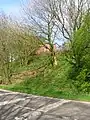 The remains of the wooden pedestrian footbridge and way up to Lugton High station.