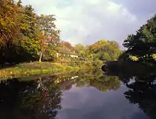 The third and only remaining pond; houses of former mill workers and bridge