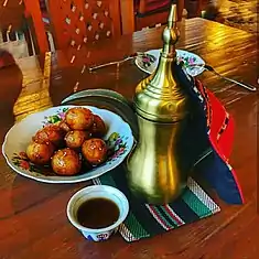 Image 12Luqaimat (lugaimat in Emirati dialect), a traditional Emirati dessert, served with Arabic coffee. (from Emirati cuisine)