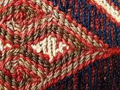 Detail of weft wrapping: "weft yarns .. can be pushed about as the weaver wishes"