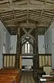 The west end of the nave in St Mary the Virgin parish church, showing the scissor-braced 15th-century frame supporting the bell-turret