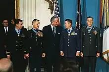 President Johnson congratulates Medal of Honor recipients at the White House on January 16, 1969. Lt. Col. Joe M. Jackson (on Johnson's left) and Major Stephen W. Pless (on Johnson's right) were both natives of the same small town of Newnan, GA and were both being honored for air rescues in Vietnam.