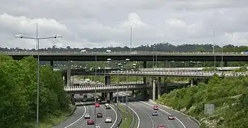 Image 23The multi-level junction between the M23 and M25 motorways near Merstham in Surrey. The M23 passes over the M25 with bridges carrying interchange slip roads for the two motorways in between.