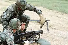 The M60 machine gun crew member responsible for a hot barrel change was issued protective asbestos gloves to prevent burns to the hands