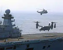 A USMC MV-22A Osprey lands on HMS Illustrious