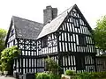 Maes Mawr, East gable and porch- jettied upper storey and quatrefoil decoration.