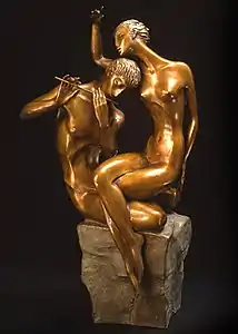 Sculpture of a man playing a flute as a woman listens