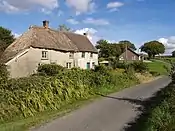 Magpie Contrasting conditions of thatch, and contrasting ages of buildings. This little group is on the lane from Sheepwash to Patchel Cross.