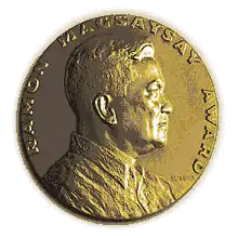 Medallion with an embossed image of Ramon Magsaysayl facing right in profile.