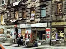 picture of exterior of dilapidated building with banners hanging