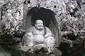 Maitreya incarnated as Budai, The Laughing Buddha, in the Feilai Feng Caves, China