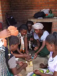 Image 26Mbawemi Women's group in Malawi learning how to add value to beeswax by making candles (from Malawi)