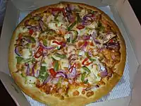 A pizza with paneer and vegetable topping from India