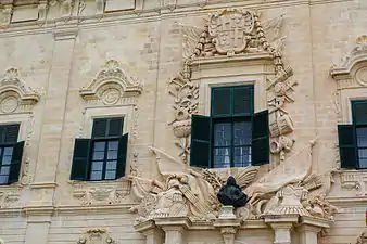 Part of the façade of Auberge de Castille (1741–45), showing Pinto's bust and coat of arms