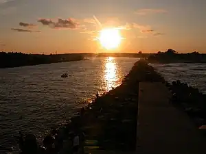 Image 37The Jersey Shore extends inland from the Atlantic Ocean into its many inlets, including Manasquan Inlet, looking westward at sunset from the jetty at Manasquan. (from New Jersey)