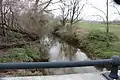 Manalapan Brook flowing under County Route 527A in Manalapan Township