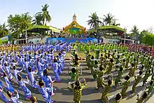 Young students wear Burmese dress and perform traditional dance during rehearsal for the opening ceremony of Mandalay City Hall Thingyan Water Festival 2012 in Mandalay, Myanmar on 10 April 2012.