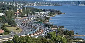 long shot of railway line with freeway on both sides