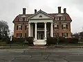 The West Mansion, designed by Portland architect Frederick A. Tompson, is located at 181 Western Promenade, at its junction with Carroll Street. It was built for the family of Maine Chamber of Commerce President George F. West in 1911 at a cost of $100,000. It has nine bedrooms and seven bathrooms.