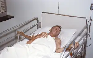 A man suffering from rabies tied to a hospital bed.