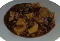 A vegetarian version of Mapo tofu from a Chinese American home in Clovis, California, in which diced shitake mushrooms were used as a substitute for ground meat.