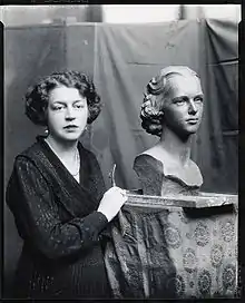 Margeret Cresson standing beside a bus of Nathalie Osborn.