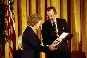 Former United Kingdom Prime Minister Margaret Thatcher receiving the award, in its unusual bow form, from President  George H. W. Bush, 1991