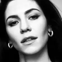 A black-and-white photograph of Marina Diamandis' face.