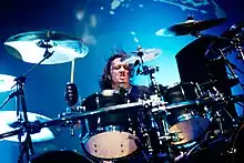 Mario Duplantier playing drums in black gloves