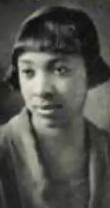 A young Black woman with hair cut in a bob with bangs