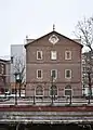 The building's western facade from across the Providence River