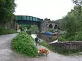 The canal swings away and passes under the railway viaduct.