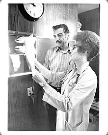 Martha Schwebach examines an X-ray with a patient