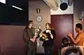 Mary Folberg receiving flowers from dancers in dressing room of Portland Center for the Performing Arts