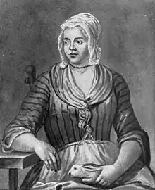 A engraving based on a painting of a young woman in poor clothing and a bonnet, sitting on a chair, holding a rabbit in her lap.  Her right elbow is supported by a table as she looks to the left, a neutral expression on her face.