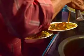 Masala puri being prepared by a street vendor