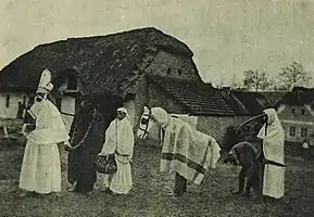 A St. Nicholas procession with Krampus, and other characters, c. 1910