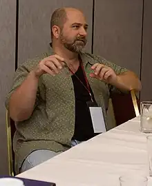 Wagner seated at a table