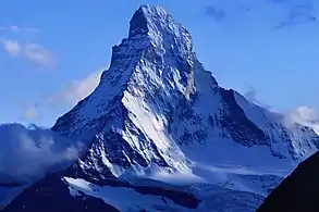 Image 4Compressed metamorphosed Tethyan sediments and their oceanic basement are sandwiched between the tip of the Matterhorn (Italian-Swiss border), which consists of gneisses originally part of the African plate, and the base of the peak, which is part of the Eurasian plate. (from Alps)