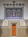 Decoration in the courtyard (a doorway surrounded by zellij and carved stucco, located below the minaret)