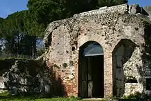 Color photograph of a masonry wall with a door.