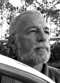 black-and-white picture of Max Hardberger looking left of camera with a straight face